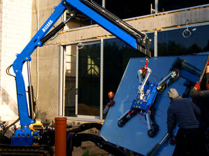 Radio-controlled mini crane on chassis tracks